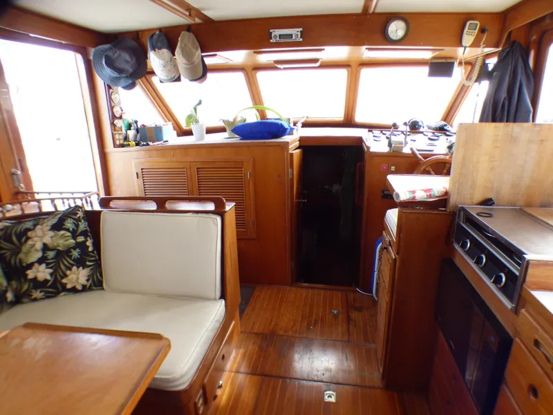 Slide: The Image of Interior of 1984 Spindrift 39 ft. Aft Cabin Twin Diesel yacht, featuring cozy seating and wooden finishes. - 25