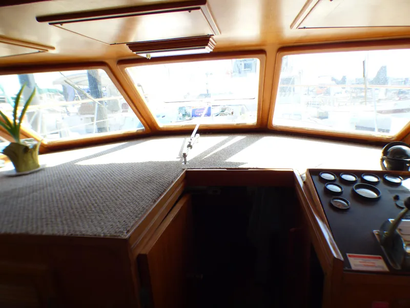Slide: The Image of 1984 Spindrift 39 ft. Aft Cabin Twin Diesel interior helm with panoramic windows and control panel. - 26
