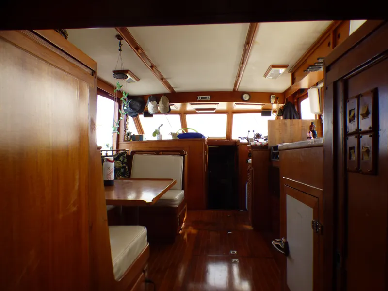 Slide: The Image of Interior of 1984 Spindrift 39 ft. Aft Cabin Twin Diesel yacht, featuring wood paneling and seating. - 28