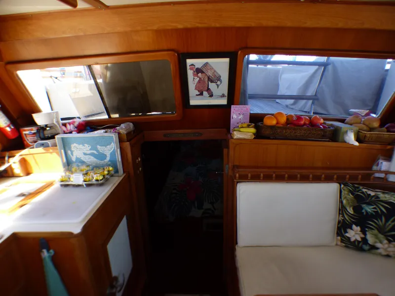 Slide: The Image of Interior of 1984 Spindrift 39 ft. Aft Cabin Twin Diesel with cozy seating and fruit display. - 29