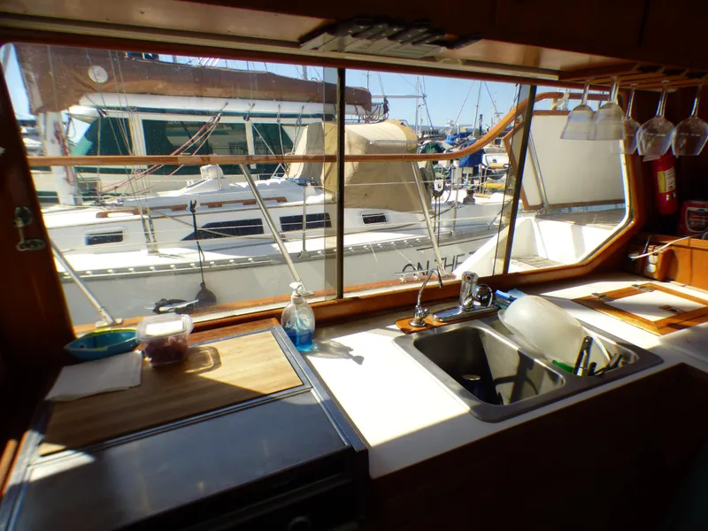 Slide: The Image of Interior view of 1984 Spindrift 39 ft. yacht kitchen with marina backdrop. - 30