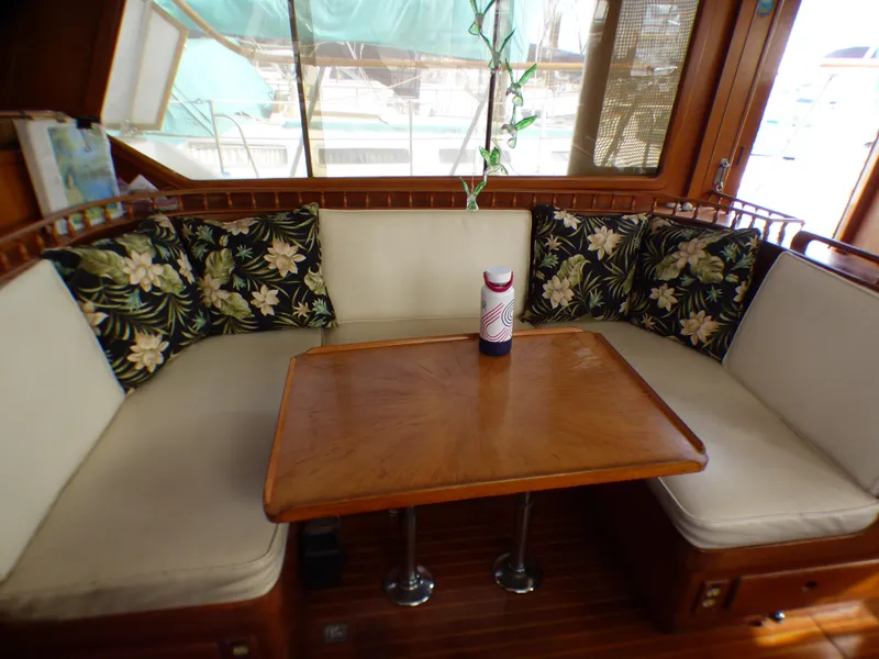 Slide: The Image of 1984 Spindrift 39 ft. aft cabin interior with cushioned seating and wooden table. - 34