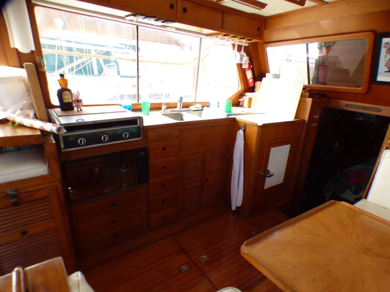 Slide: The Image of 1984 Spindrift 39 ft. Aft Cabin interior with wooden cabinetry and kitchen area. - 35