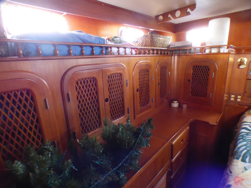 Slide: The Image of Interior of 1984 Spindrift 39 ft. Aft Cabin, featuring wooden cabinetry and cozy decor. - 46