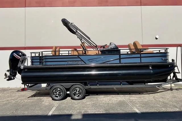 The Image of 2026 Ranger Reata 220F pontoon boat on trailer, parked outdoors. - 0