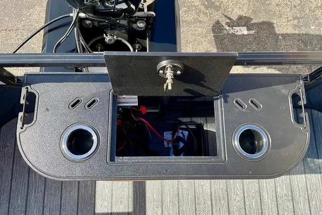 Slide: The Image of 2026 Ranger Reata 220F boat console with storage compartment and cup holders. - 19
