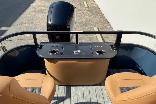 Slide: The Image of 2026 Ranger Reata 220F boat interior with tan seats and motor view. - 23