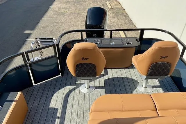 Slide: The Image of 2026 Ranger Reata 220F boat interior with tan seats and modern design. - 24