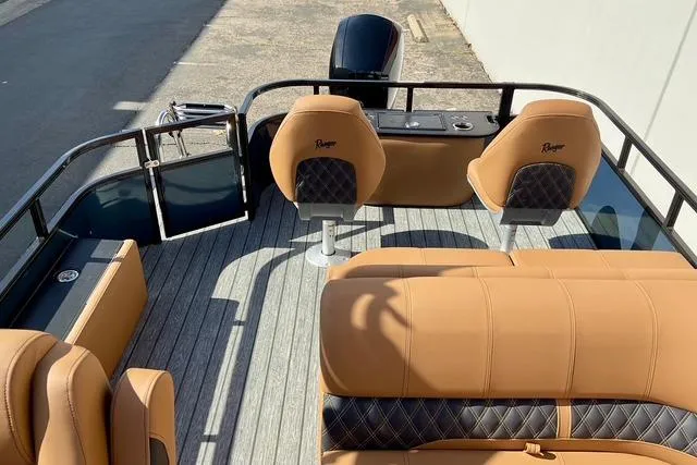 Slide: The Image of 2026 Ranger Reata 220F boat interior with tan leather seats and modern design. - 25