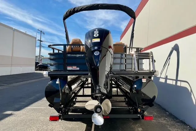 Slide: The Image of 2026 Ranger Reata 220F pontoon boat with powerful outboard motor, parked outdoors. - 3