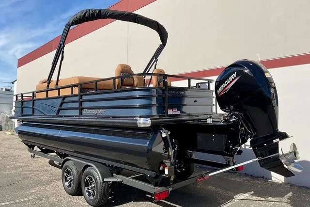 Slide: The Image of 2026 Ranger Reata 220F pontoon boat with Mercury outboard motor on a trailer. - 6