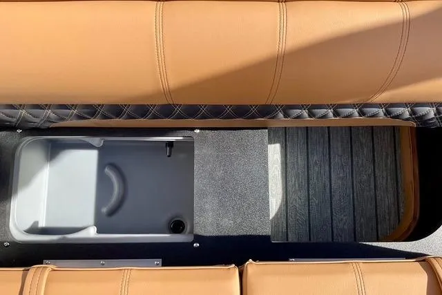 Slide: The Image of 2026 Ranger Reata 220F boat interior with tan seating and storage compartment. - 8