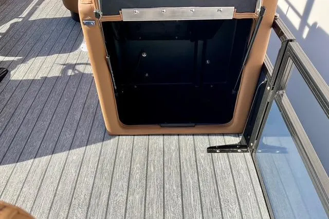 Slide: The Image of 2026 Ranger Reata 220F boat interior with open storage compartment and sleek flooring. - 9