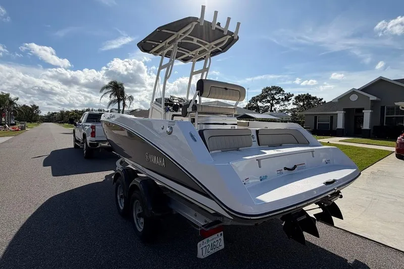 Slide: The Image of 2022 Yamaha Boats 210 FSH Sport on trailer, parked in suburban neighborhood. - 12