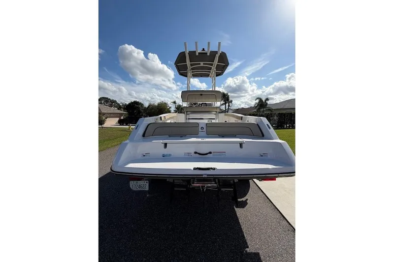 Slide: The Image of 2022 Yamaha Boats 210 FSH Sport, rear view under sunny sky. - 13
