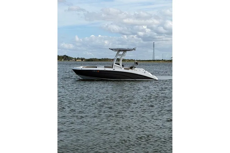 Slide: The Image of 2022 Yamaha Boats 210 FSH Sport on calm water under cloudy sky. - 3