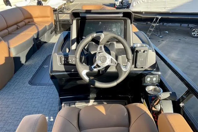 Slide: The Image of 2026 Regency 250DL boat dashboard with steering wheel and seating area. - 12