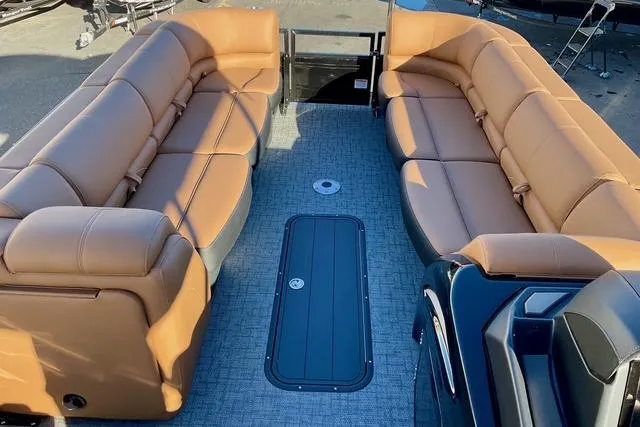 Slide: The Image of Luxurious 2026 Regency 250DL pontoon boat with spacious tan seating and modern design. - 13