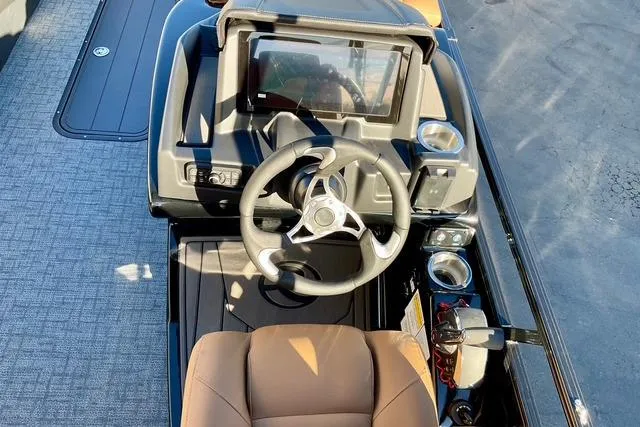 Slide: The Image of Steering console of 2026 Regency 250DL boat with modern controls and brown seating. - 15