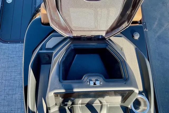 Slide: The Image of Open storage compartment of 2026 Regency 250DL boat, showcasing interior design and features. - 16