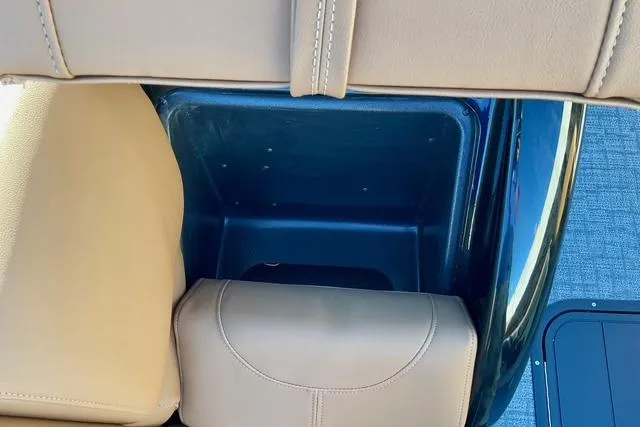 Slide: The Image of Interior storage compartment of 2026 Regency 250DL boat with beige seating. - 22