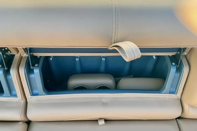 Slide: The Image of Rear seat storage compartment in 2026 Regency 250DL with beige leather upholstery. - 25