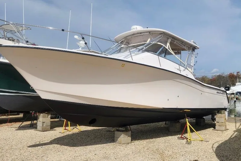 The Image of 2004 Grady-White Express 330 boat on blocks, side view, outdoors. - 0