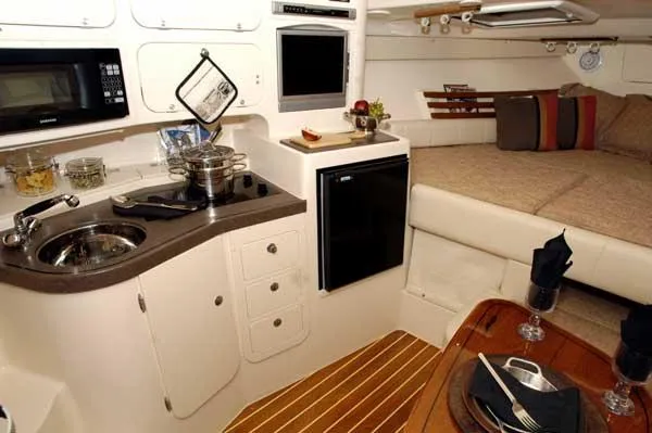 Slide: The Image of 2004 Grady-White Express 330 cabin interior with seating and storage. - 16