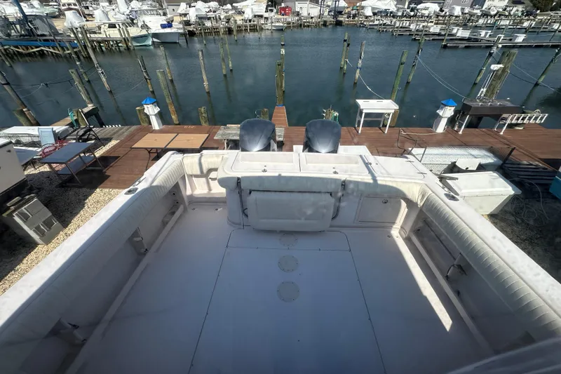 Slide: The Image of 2004 Grady-White Express 330 boat docked at a marina with dual engines. - 29