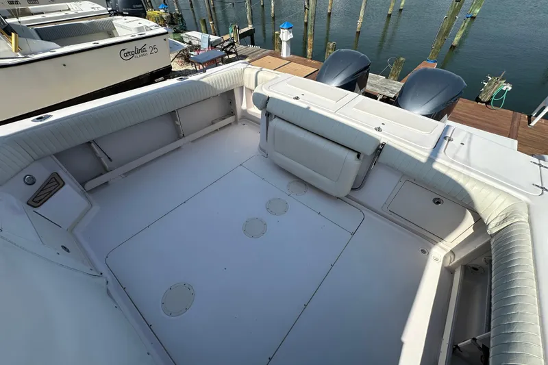 Slide: The Image of 2004 Grady-White Express 330 boat deck with seating, docked by the water. - 30