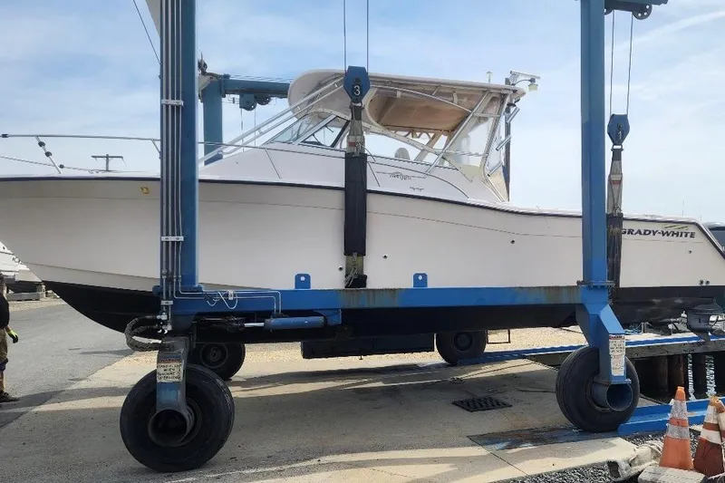 Slide: The Image of 2004 Grady-White Express 330 boat on a lift at a marina. - 4