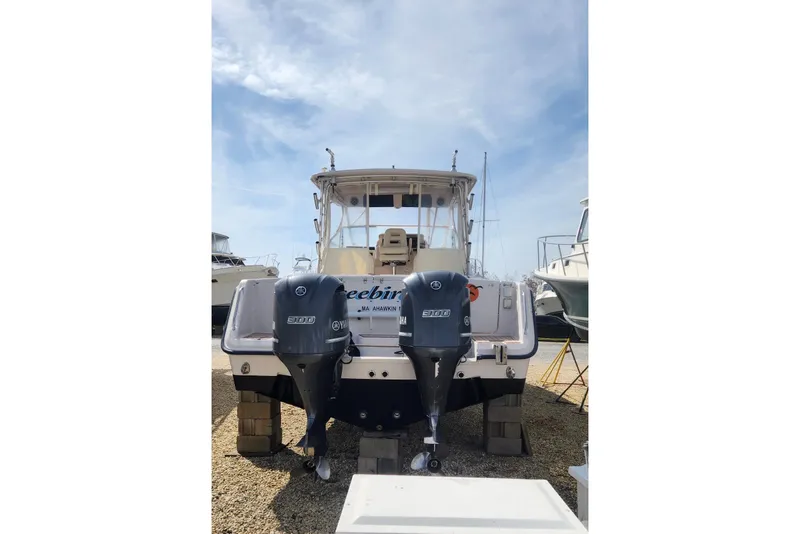 Slide: The Image of 2004 Grady-White Express 330 boat with twin Yamaha 300 engines, docked outdoors. - 7