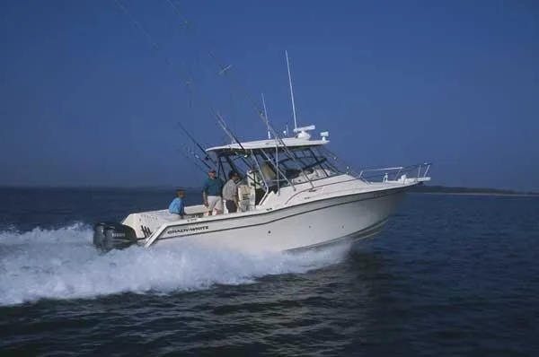 Slide: The Image of 2004 Grady-White Express 330 boat interior with beige seating and covered deck. - 8