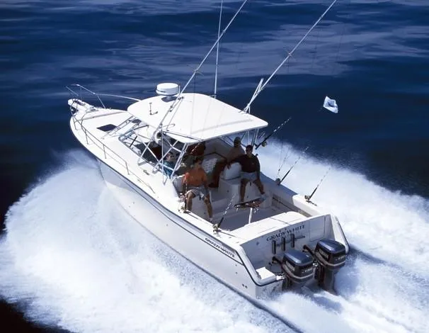 Slide: The Image of 2004 Grady-White Express 330 boat interior with cushioned seating and fishing rod holders. - 9