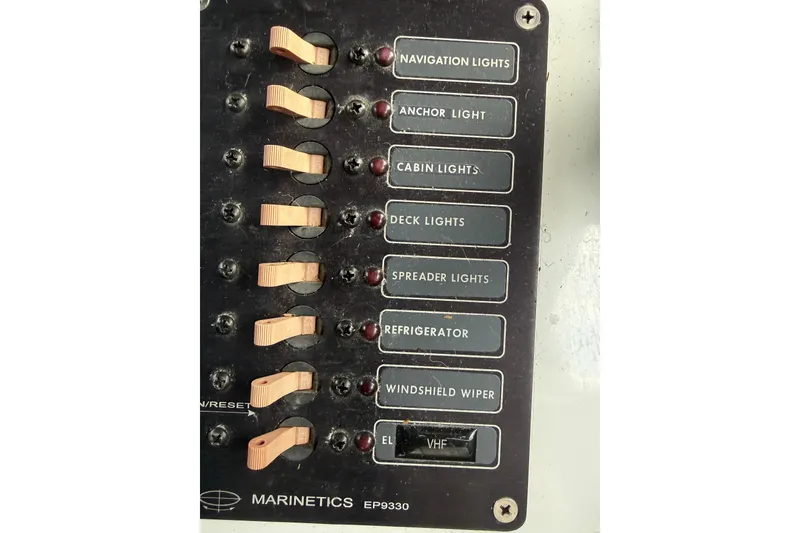 Slide: The Image of Control panel of a 1998 Davis Rock Harbor 25 boat with labeled switches. - 16