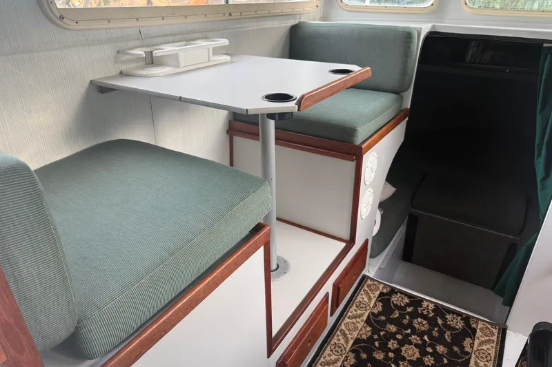 Slide: The Image of Interior of 1998 Davis Rock Harbor 25 boat with seating and table setup. - 17