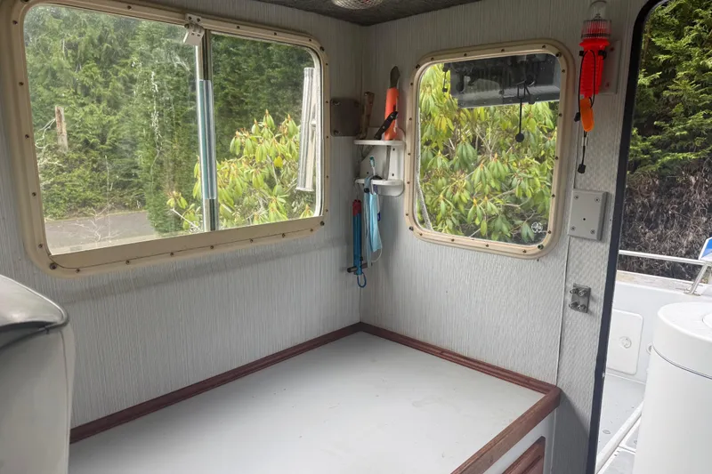 Slide: The Image of Interior of a 1998 Davis Rock Harbor 25 boat with windows and storage shelves. - 21