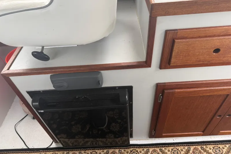 Slide: The Image of Interior of 1998 Davis Rock Harbor 25 boat with wooden cabinetry and seating. - 23