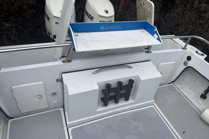 Slide: The Image of 1998 Davis Rock Harbor 25 boat deck with Magma cutting board and Evinrude engines. - 25