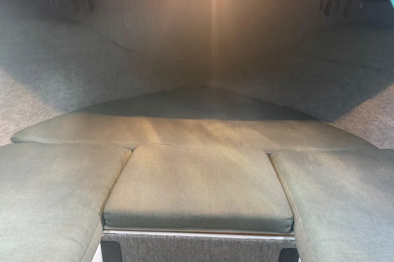 Slide: The Image of Interior cabin of a 1998 Davis Rock Harbor 25 boat, featuring cushioned seating. - 7