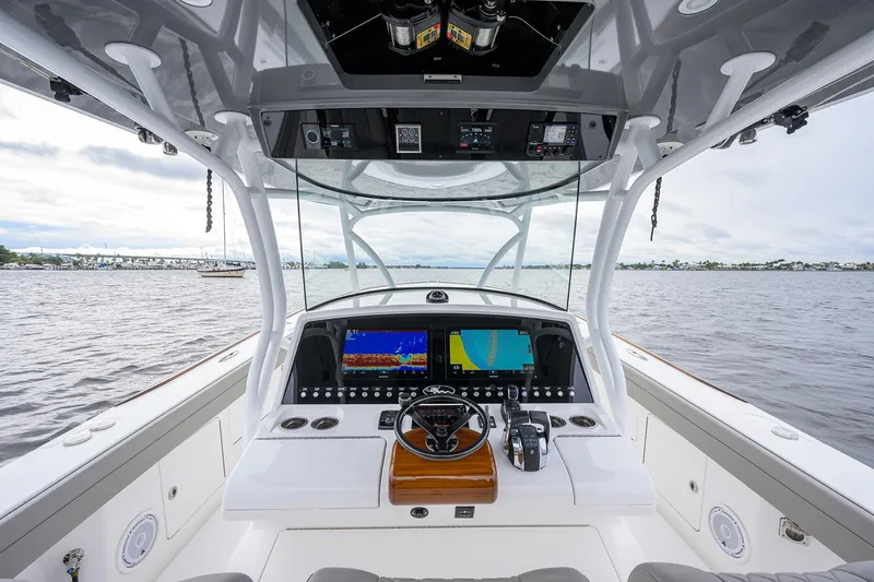 Slide: The Image of 2024 Valhalla Boatworks V-41 helm with advanced navigation systems on open water. - 11