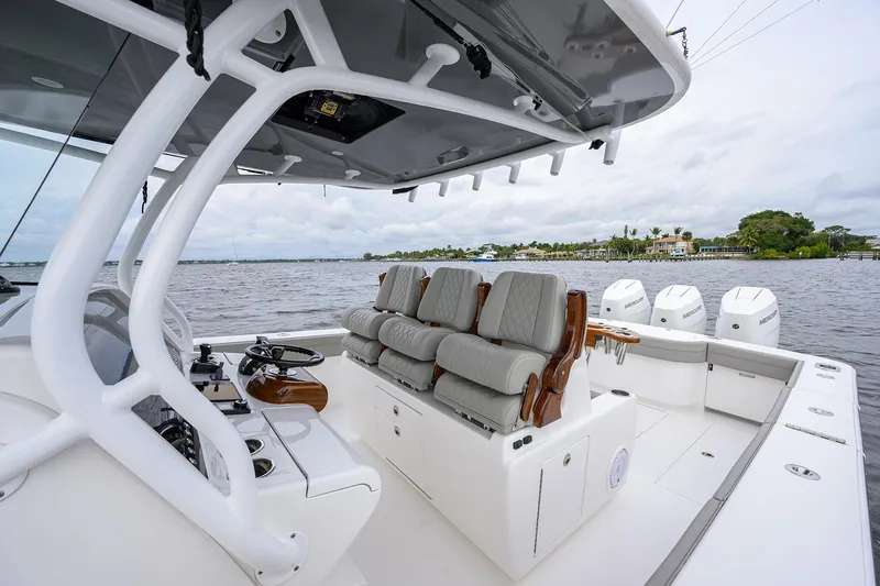 Slide: The Image of 2024 Valhalla Boatworks V-41 interior with luxurious seating and advanced controls on the water. - 21