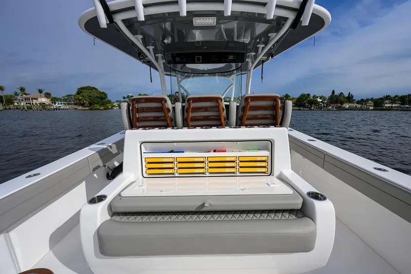 Slide: The Image of 2024 Valhalla Boatworks V-41 interior with seating and storage on a calm waterway. - 27