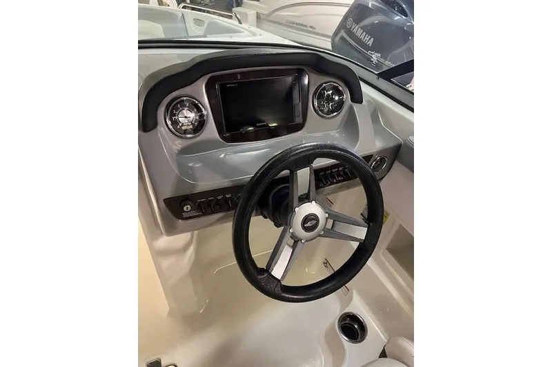Slide: The Image of 2020 Chaparral 23 SSi boat dashboard with steering wheel and controls. - 2