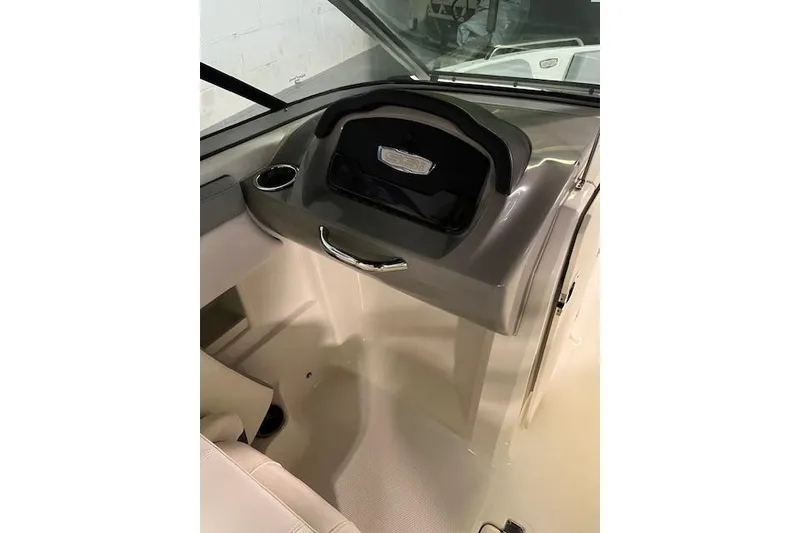 Slide: The Image of 2020 Chaparral 23 SSi boat interior dashboard with storage compartment. - 3