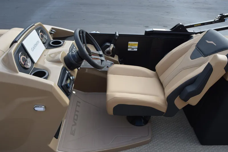 Slide: The Image of 2026 Evotti 525QL boat cockpit with tan seating and Garmin navigation system. - 11