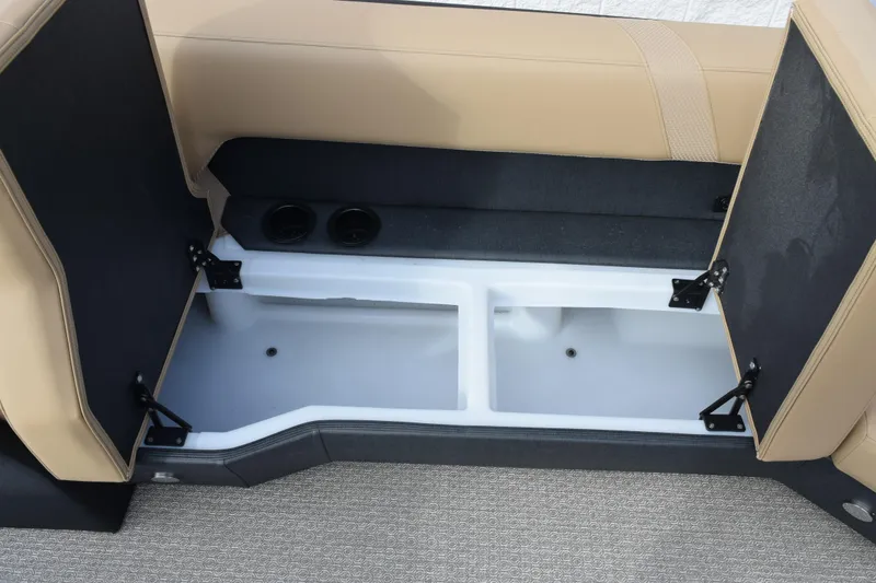 Slide: The Image of Open storage compartment in 2026 Evotti 525QL boat with beige seating. - 18