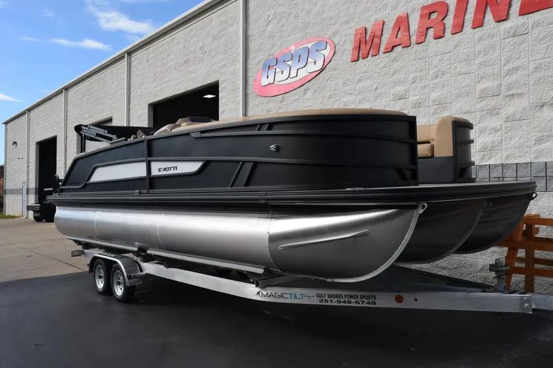 Slide: The Image of 2026 Evotti 525QL pontoon boat on trailer outside marine dealership. - 2