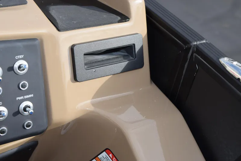 Slide: The Image of Control panel of 2026 Evotti 525QL boat with switches and storage compartment. - 26