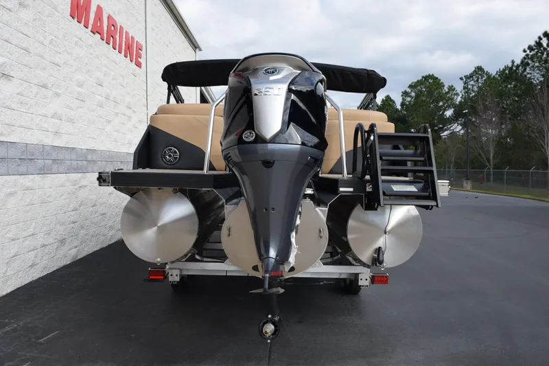 Slide: The Image of 2026 Evotti 525QL pontoon boat with powerful outboard motor, parked near a marine facility. - 5